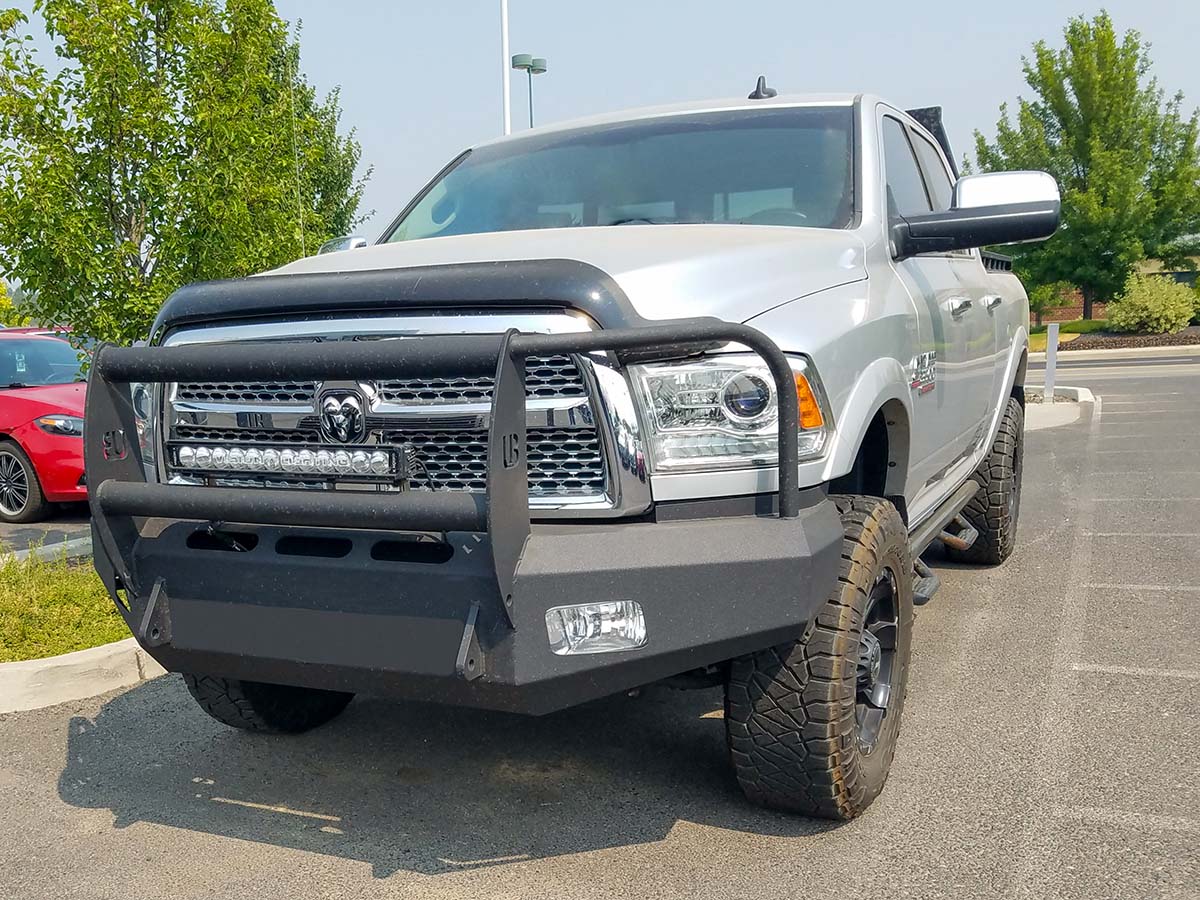 Silver pick-up truck with a large black bumper.