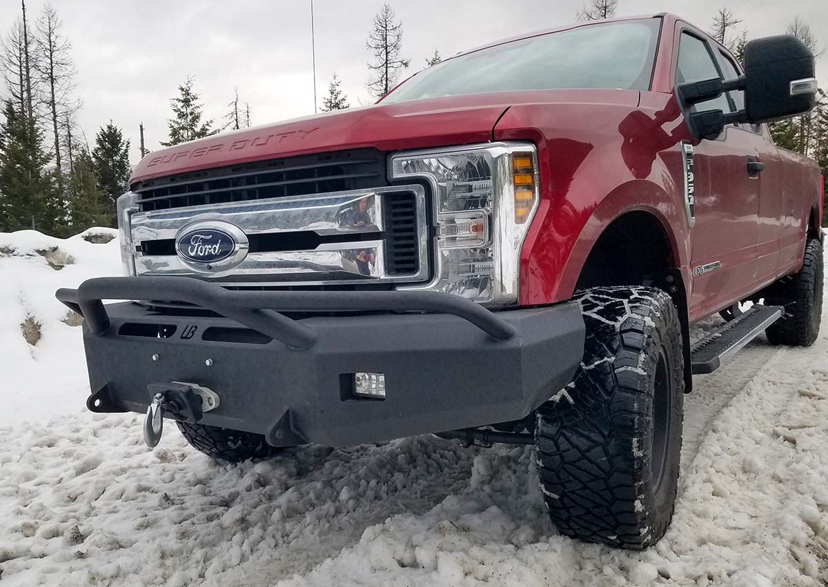 Large red ford pick-up truck with a black bumper. 