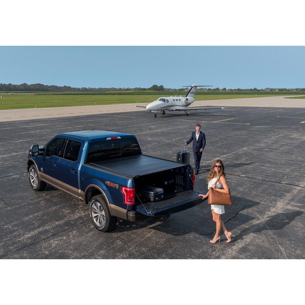 Two people walking to a truck on a plane roadway.