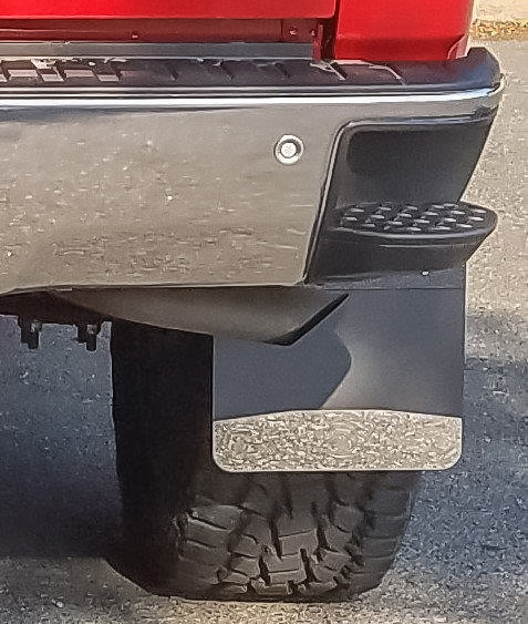 Close up a mud flap on a red truck.